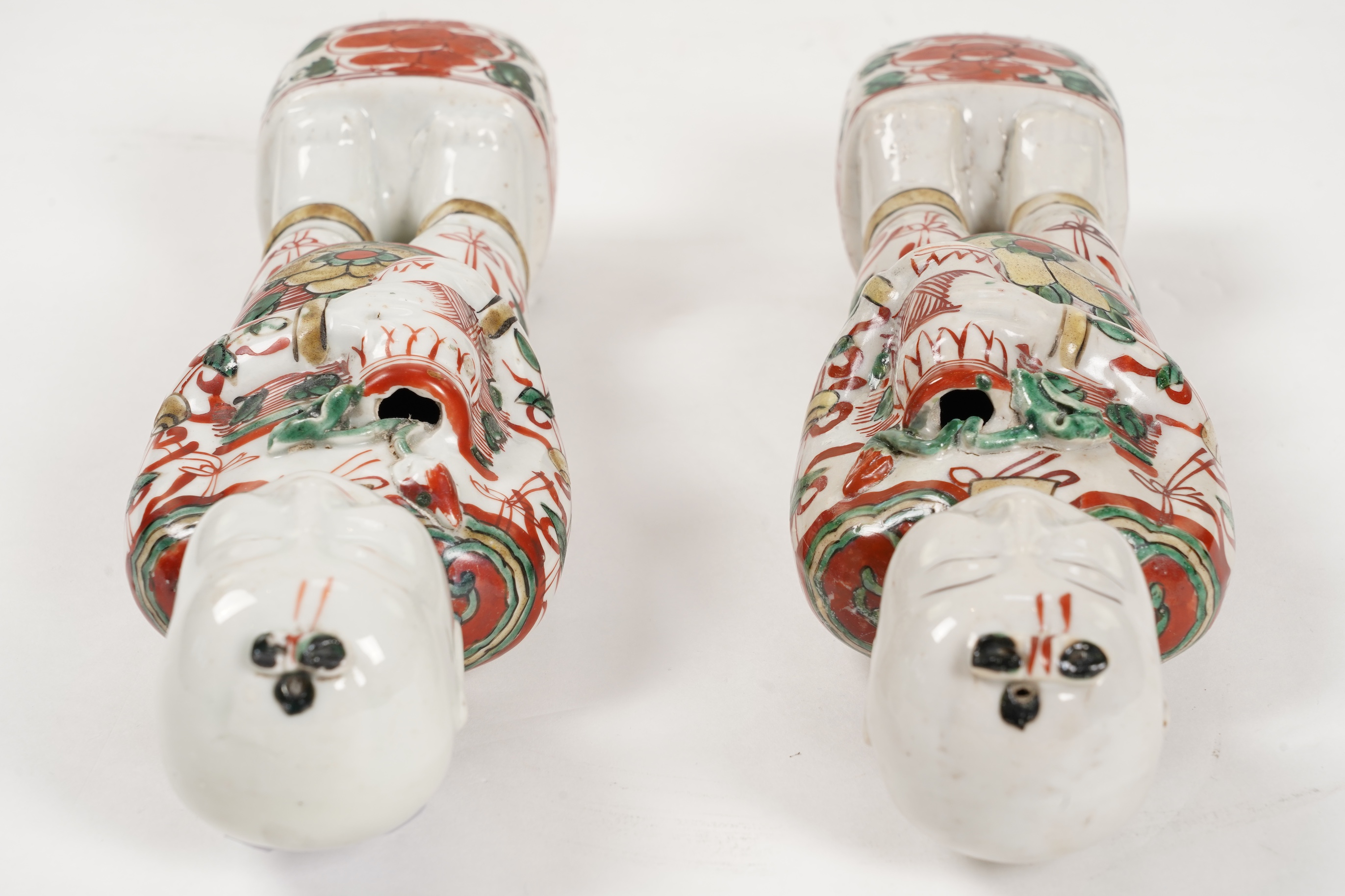 A pair of Chinese famille verte figures of smiling boys, Kangxi period